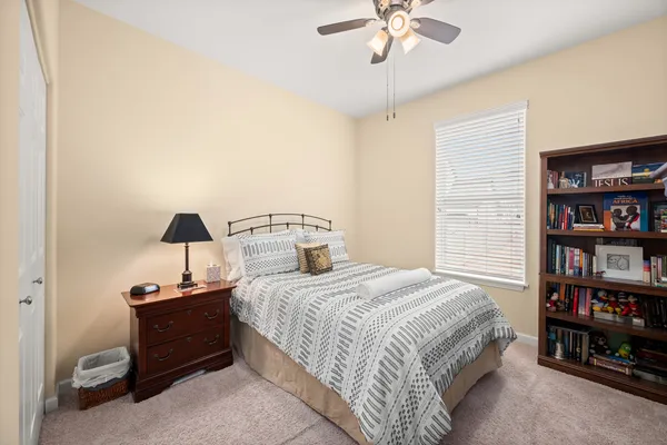 a bedroom with a bed and a chandelier
