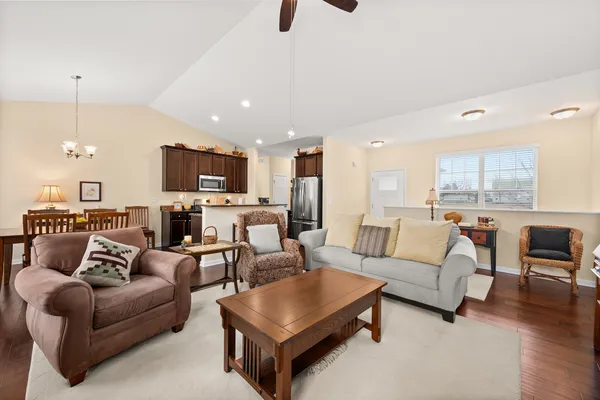 a living room with furniture and a view of kitchen