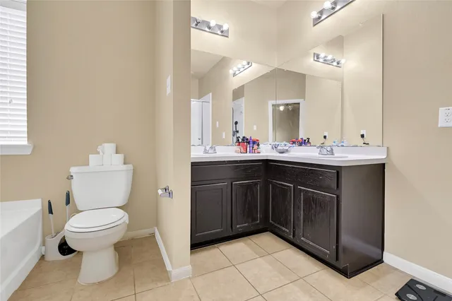 a bathroom with a sink toilet and a mirror