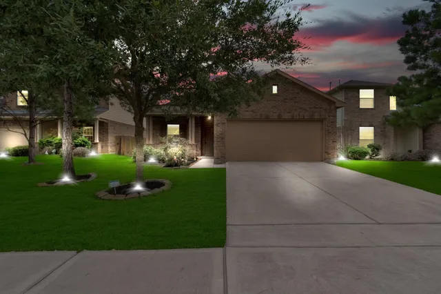 a front view of house with yard and green space