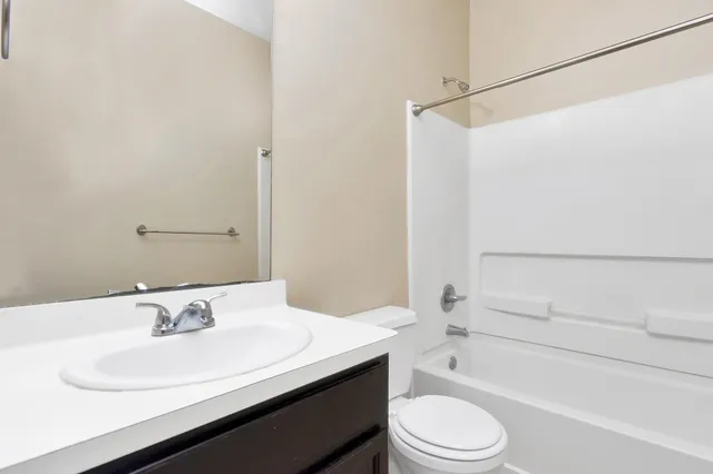 a bathroom with a sink a toilet and a bathtub
