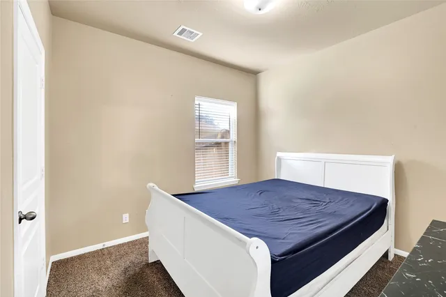 a bedroom with a bed and window