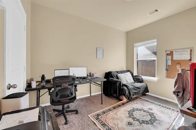 a livingroom with workspace and a window