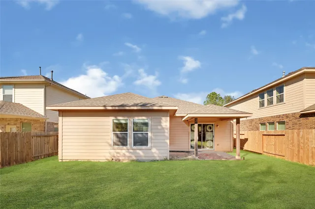 a front view of a house with a garden and yard