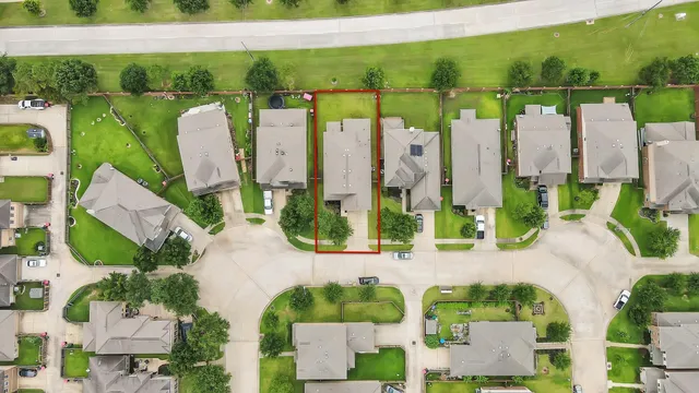 an aerial view of a garden with swimming pool and outdoor seating