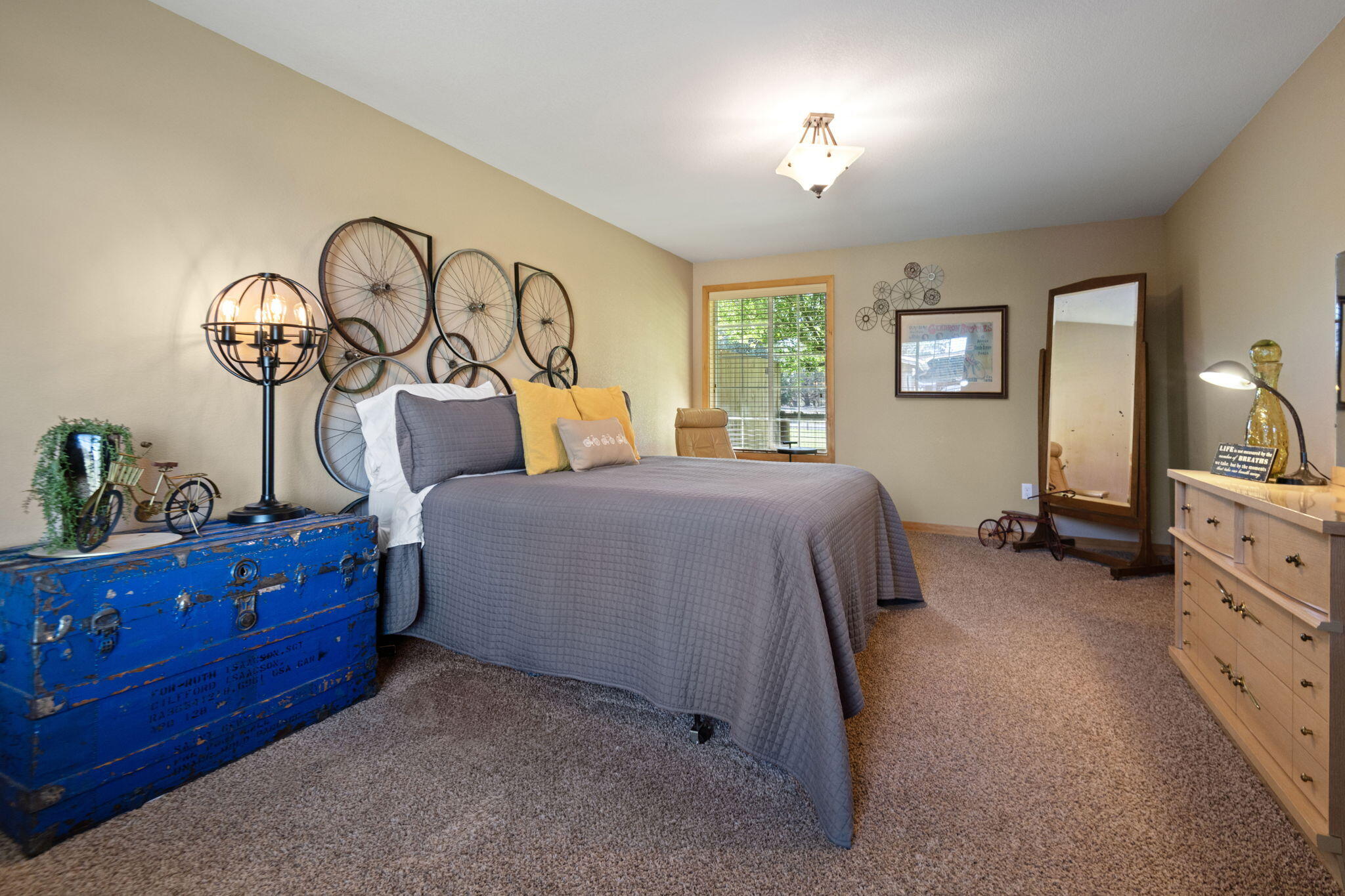 22539 Martee Lane Bend, OR 97701 - Photo 18 of 54 a spacious bedroom with a bed and a dresser in it