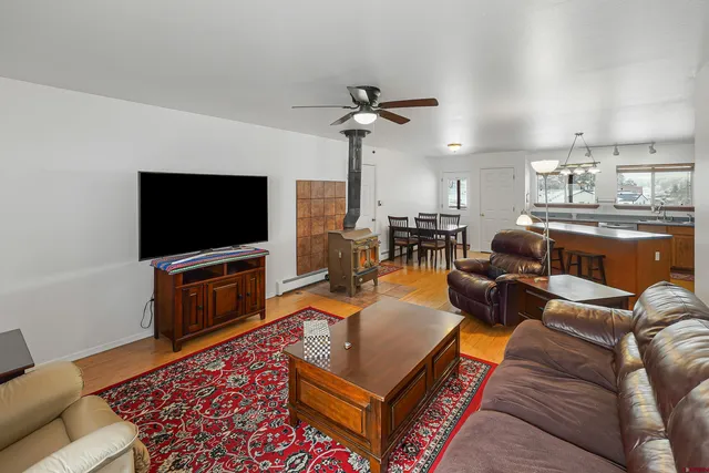a living room with furniture and a wooden floor