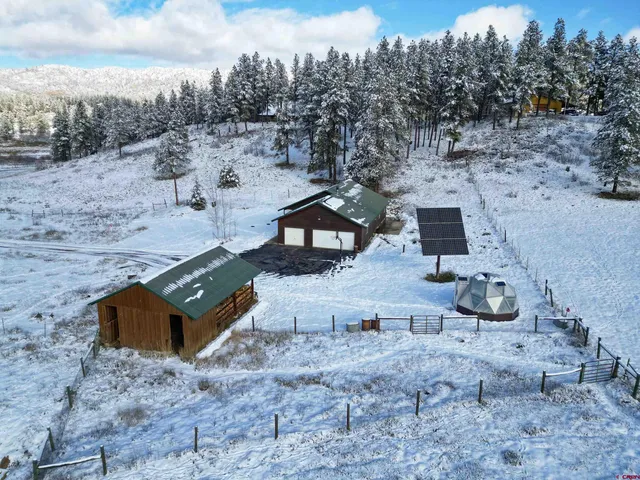 an aerial view of a house with trees