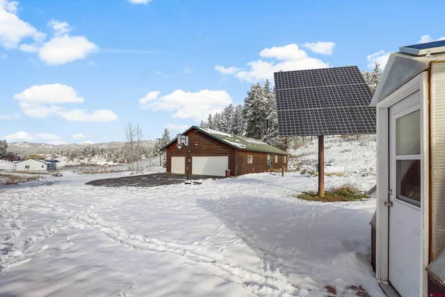 a front view of a house with a yard covered in snow