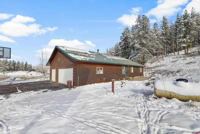 a view of a yard with snow on the road