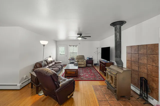 a kitchen with stainless steel appliances granite countertop wooden floor window and refrigerator
