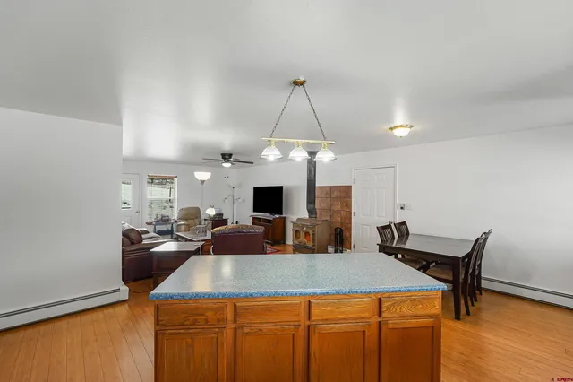 a living room with furniture a window and kitchen view
