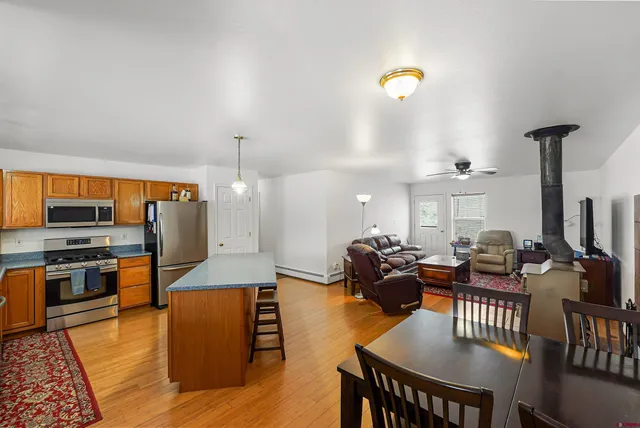 a kitchen with stainless steel appliances granite countertop a refrigerator stove and sink