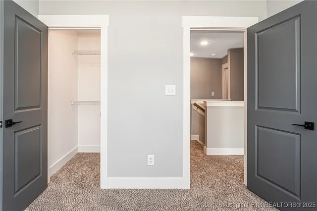 a bathroom with a granite countertop sink a toilet and a mirror