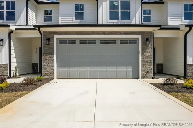 a front view of a house with parking area