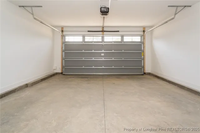 a view of a white house with a swimming pool in front of it