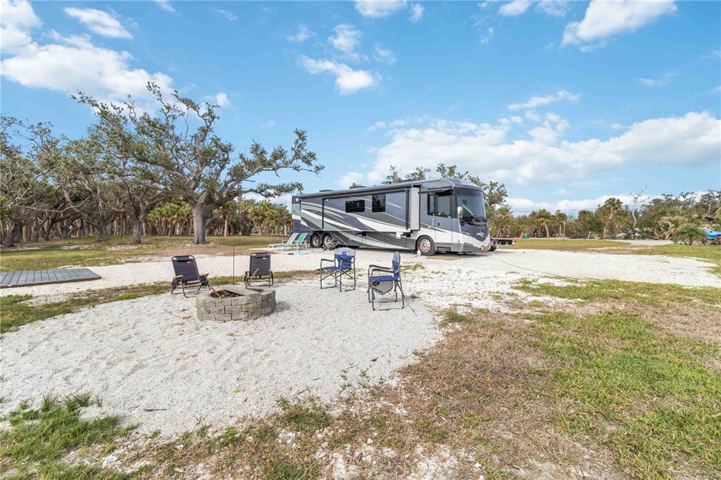 12350 Placida Road Placida, FL 33946 - Photo 11 of 17 view of a lake with a yard and wooden fence