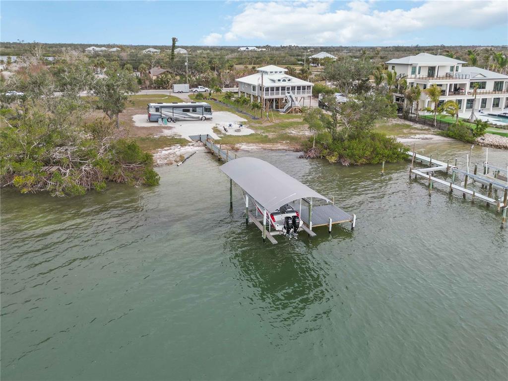 12350 Placida Road Placida, FL 33946 - Photo 5 of 17 a view of a lake with building in front of it