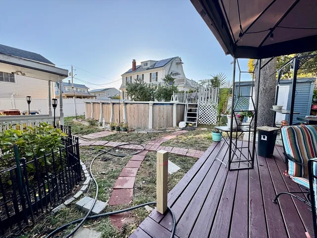 a view of balcony with wooden floor and outdoor seating