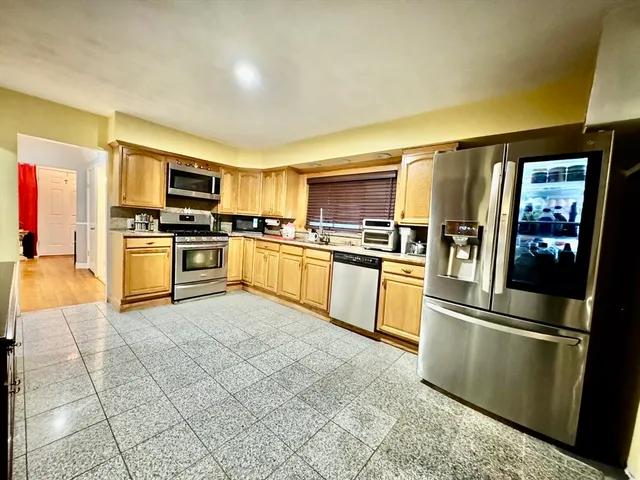 a kitchen with granite countertop stainless steel appliances and white cabinets
