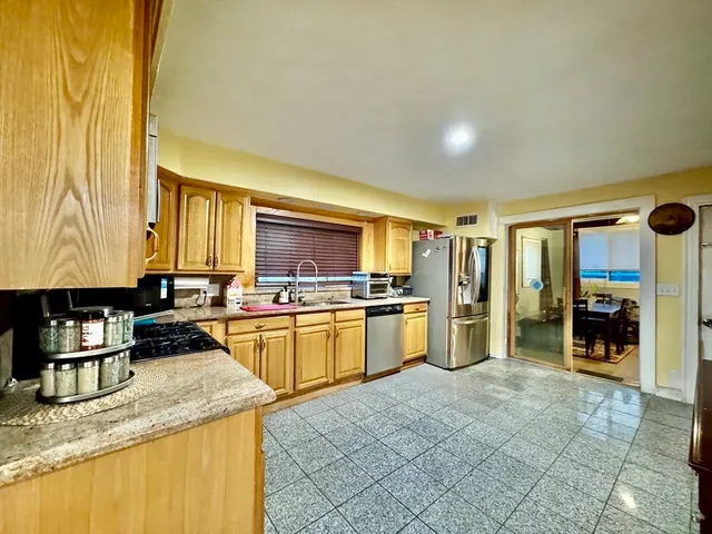 a kitchen with stainless steel appliances granite countertop a sink and cabinets