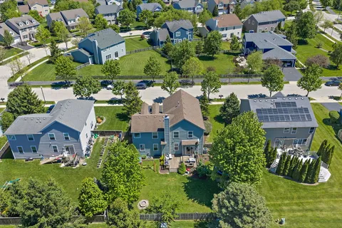 an aerial view of residential houses with yard