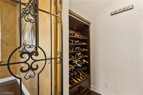 a kitchen with stainless steel appliances kitchen island granite countertop a stove a sink a dining table and chairs with wooden floor