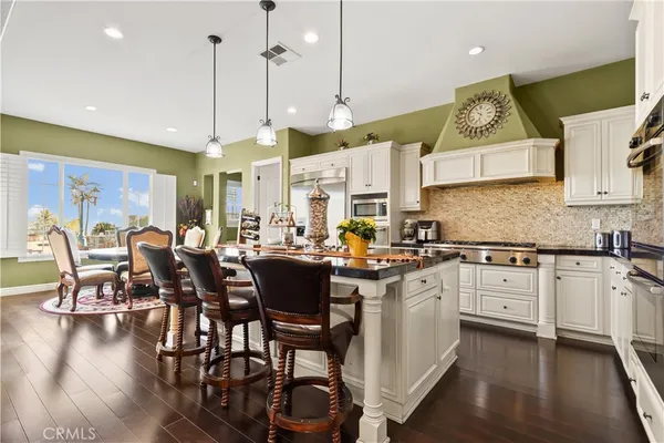 a kitchen with stainless steel appliances a sink a stove and a refrigerator
