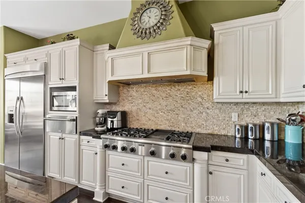 a kitchen with granite countertop a sink counter top space and living room view