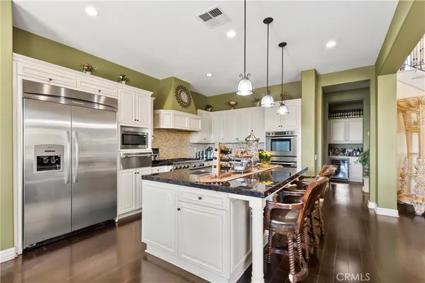 a view of a dining room with furniture and chandelier