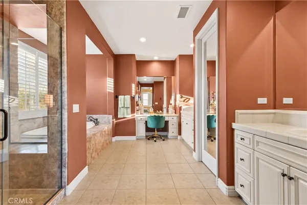 a bedroom with a bed and large windows