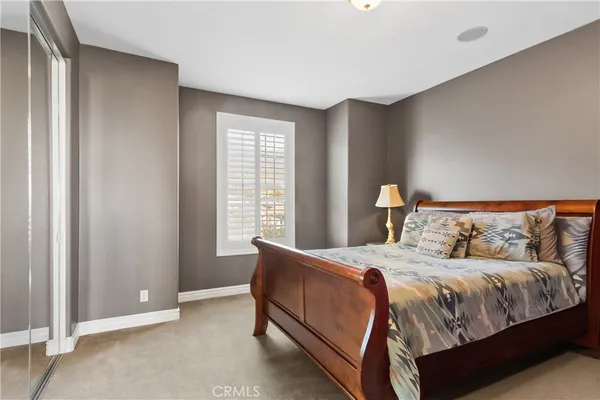 a view of a swimming pool with lawn chairs and a fire pit