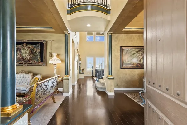 a living room with furniture a fireplace and a large window