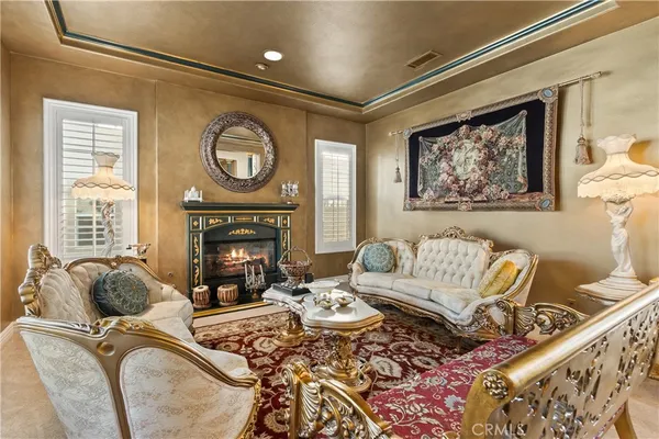 a living room with furniture and floor to ceiling windows