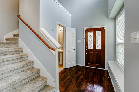 a view of entryway and hall with wooden floor
