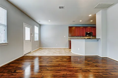 a kitchen with stainless steel appliances granite countertop a sink counter space cabinets and a large window