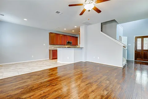 a view of a kitchen with kitchen island stainless steel appliances refrigerator stove microwave and cabinets