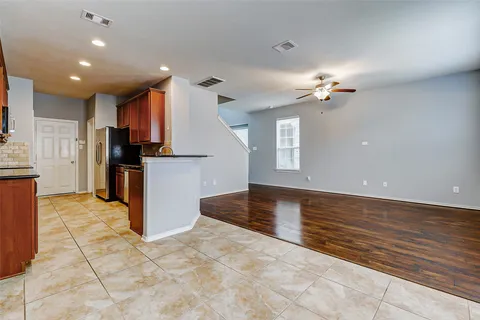 a kitchen with stainless steel appliances granite countertop a stove a sink dishwasher and a refrigerator