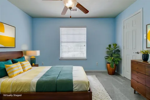 a bedroom with a bed and a potted plant