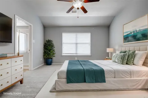 a bedroom with a large bed and a flat screen tv