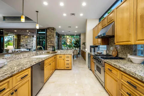 a bathroom with a bathtub shower sink mirror and toilet