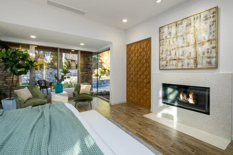 a room with a table chairs and wooden floor