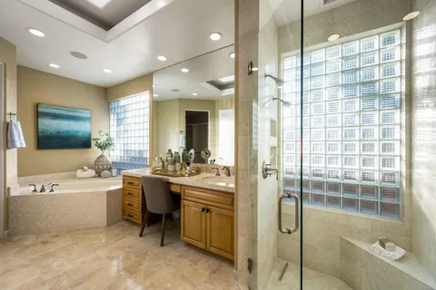 a bathroom with a granite countertop sink a toilet and a mirror