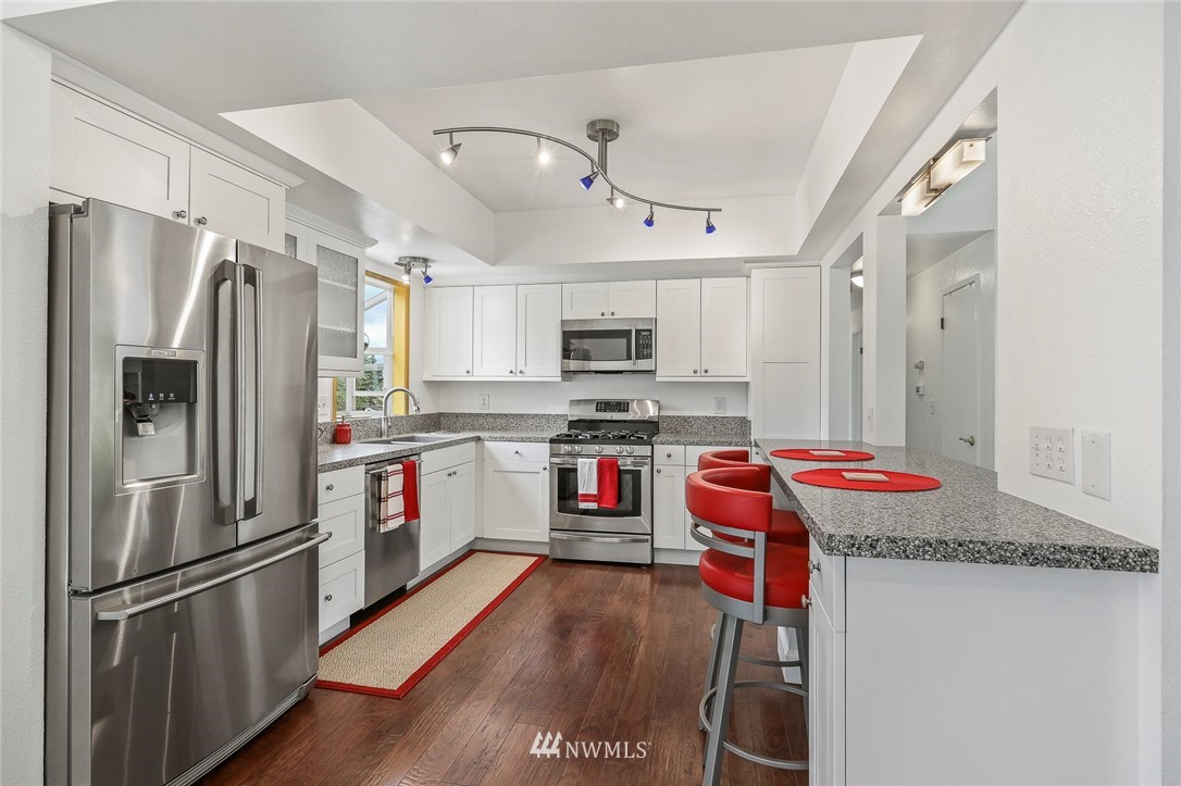 19230 90th Place Northeast Bothell, WA 98011 - Photo 2 of 40 a kitchen with stainless steel appliances granite countertop a refrigerator a stove and a sink