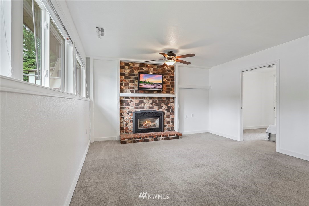 19230 90th Place Northeast Bothell, WA 98011 - Photo 12 of 40 a view of a livingroom with a fireplace and window
