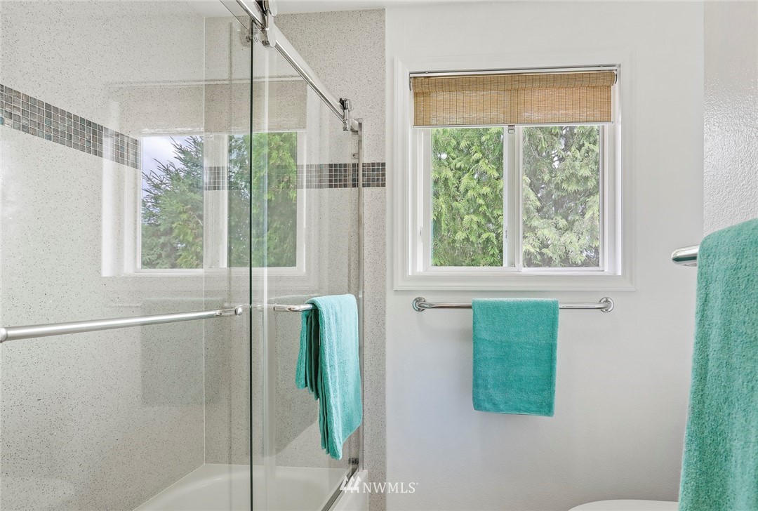 19230 90th Place Northeast Bothell, WA 98011 - Photo 19 of 40 a bathroom with a glass shower and windows