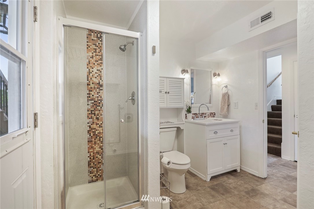 19230 90th Place Northeast Bothell, WA 98011 - Photo 22 of 40 a bathroom with a granite countertop sink toilet and shower