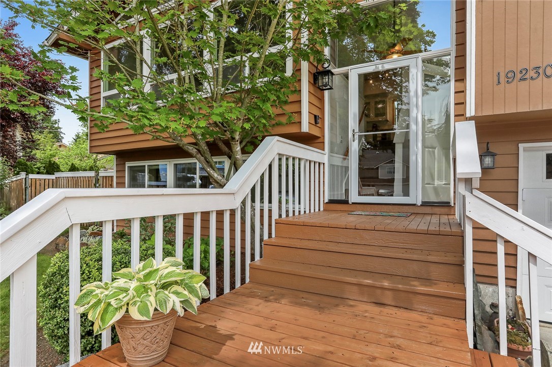 19230 90th Place Northeast Bothell, WA 98011 - Photo 26 of 40 a balcony with potted plants and brick walls