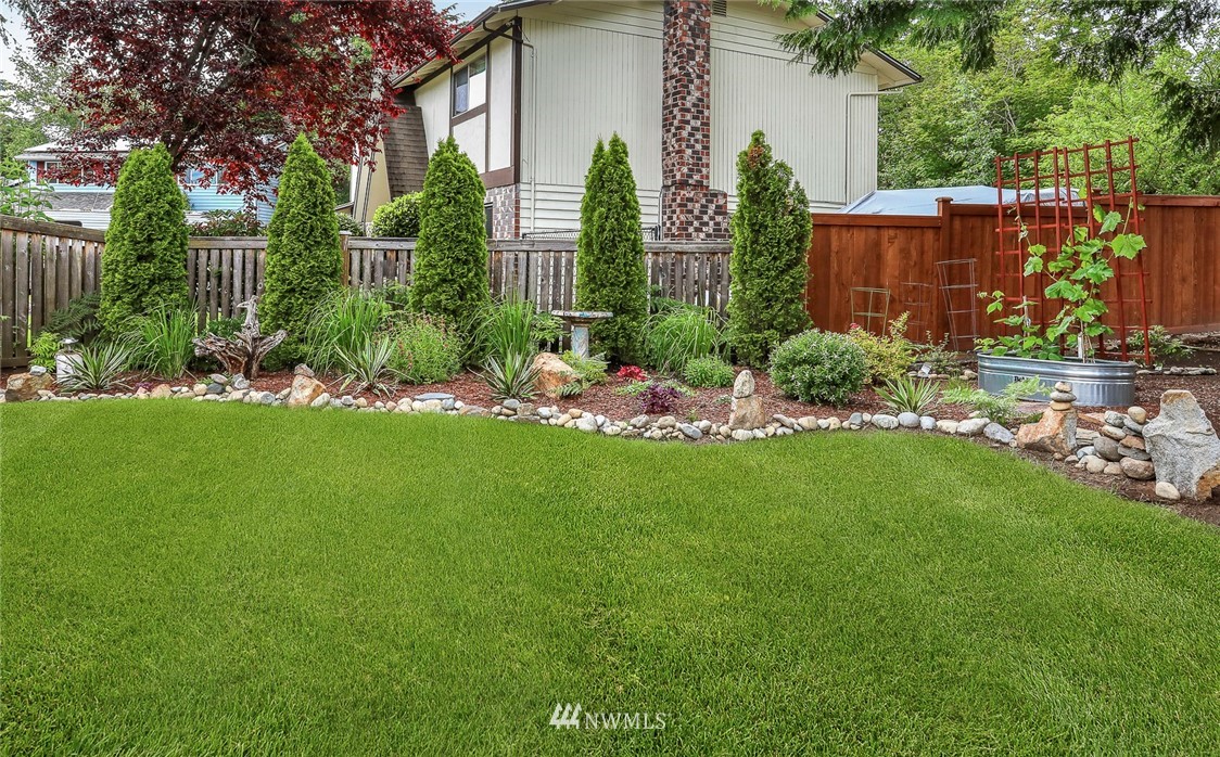 19230 90th Place Northeast Bothell, WA 98011 - Photo 35 of 40 a view of a backyard with plants and a fountain