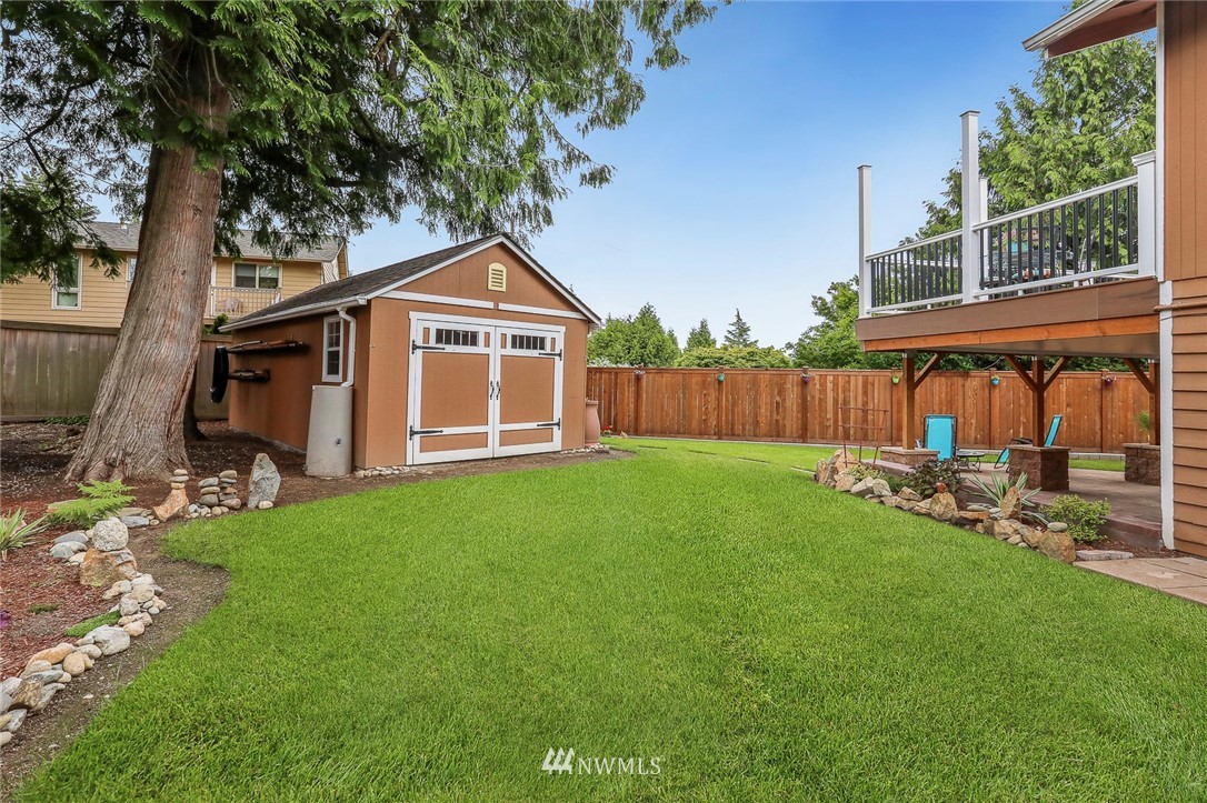 19230 90th Place Northeast Bothell, WA 98011 - Photo 36 of 40 a view of a backyard with table and chairs and a fire pit